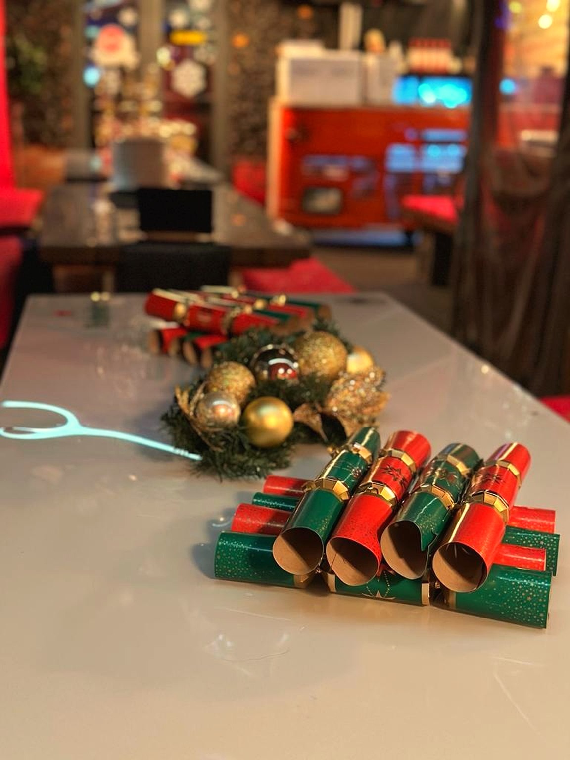Christmas crackers and wreath on a festive table